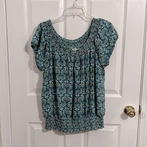 Large turquoise and blue smocked collar with a cutout.
